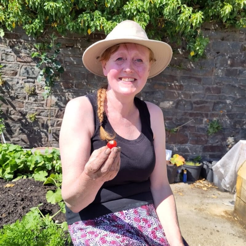 Volunteer holding a strawberry