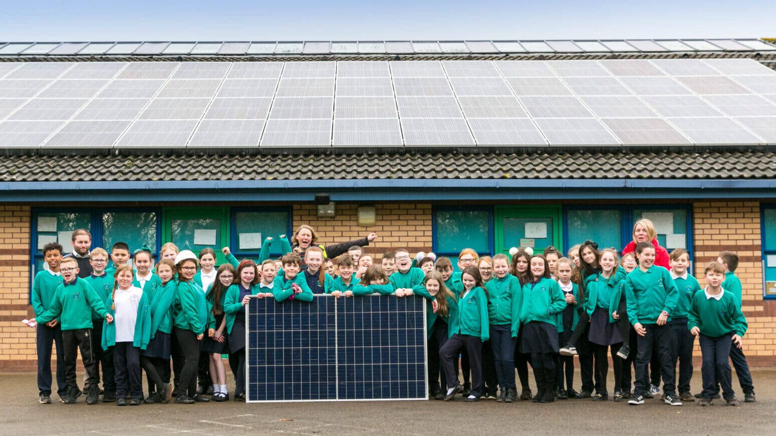 Pupils with solar panels on their school